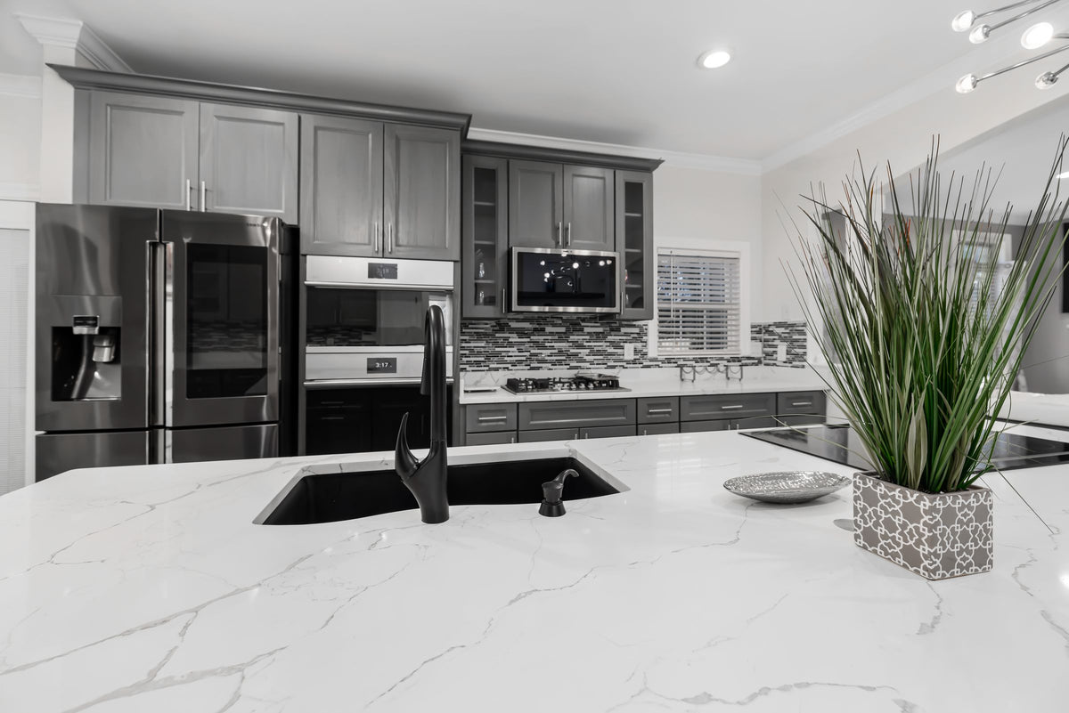 Kitchen island with a white veined quartz countertop