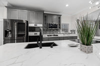 Kitchen island with a white veined quartz countertop