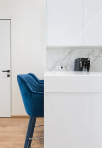 White veined stone countertop with a waterfall edge