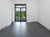 Large-format grey porcelain floor tile in an empty room