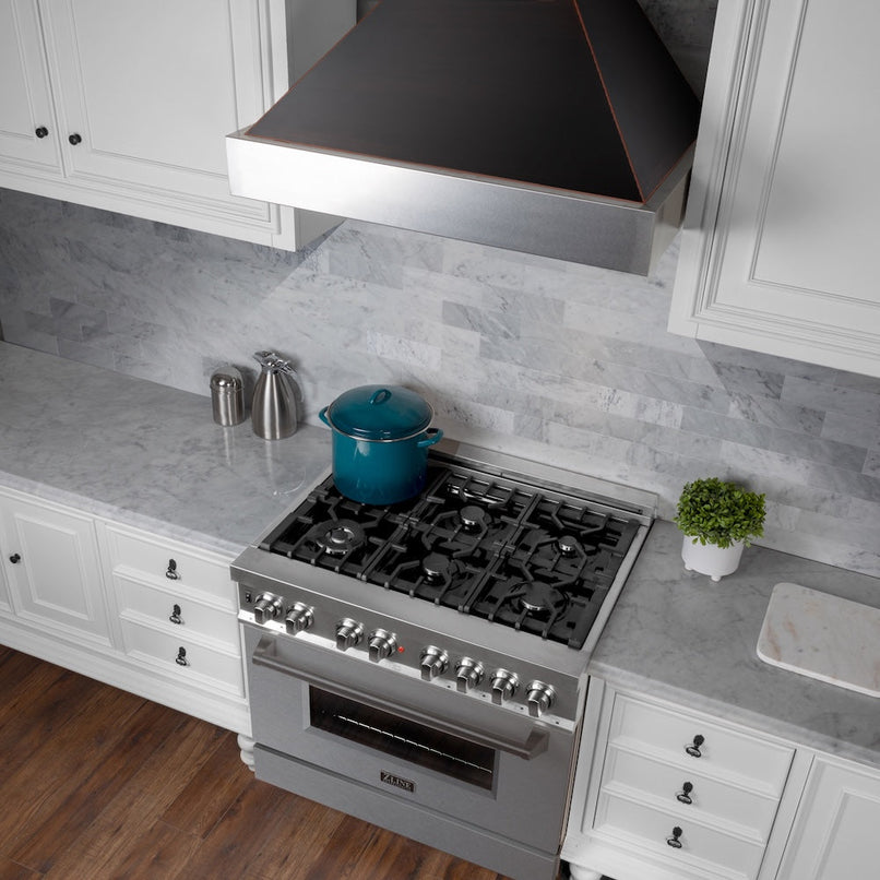 ZLINE 36 in. Ducted Satin Stainless Steel Wall Mount Range Hood with Oil Rubbed Bronze Shell (8654ORB-36) in a luxury kitchen.